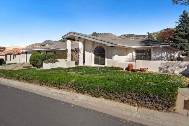 view of front facade featuring a garage and a front lawn