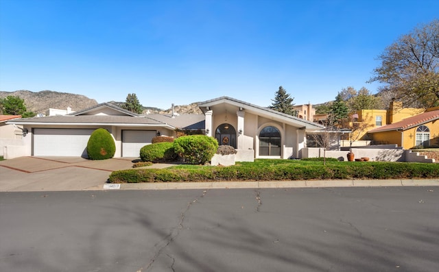 view of front of home with a mountain view and a garage