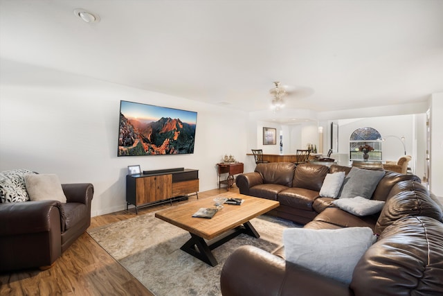 living room with ceiling fan and light hardwood / wood-style floors