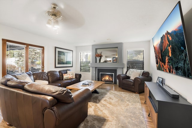 living room with light wood-type flooring and ceiling fan