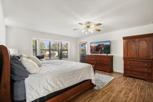 bedroom with light wood-type flooring and ceiling fan