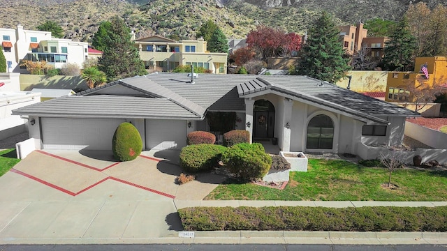 view of front of house featuring a garage and a front lawn