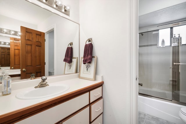 full bathroom with tile patterned floors, vanity, toilet, and enclosed tub / shower combo