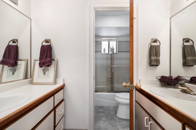 full bathroom featuring shower / bath combination with glass door, vanity, toilet, and tile patterned flooring