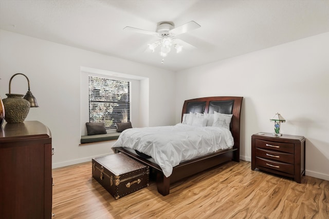 bedroom with ceiling fan and light hardwood / wood-style floors