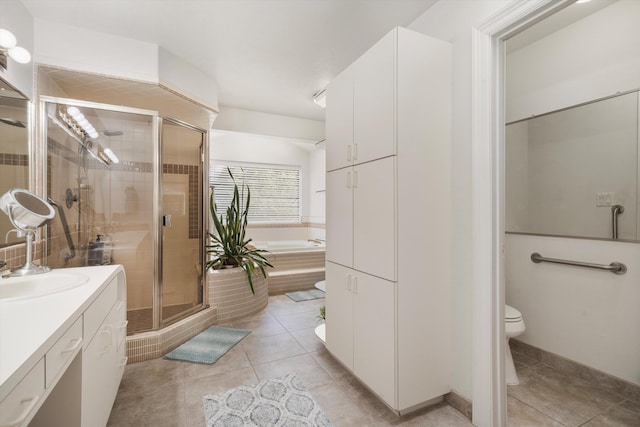 full bathroom with tile patterned flooring, shower with separate bathtub, vanity, and toilet