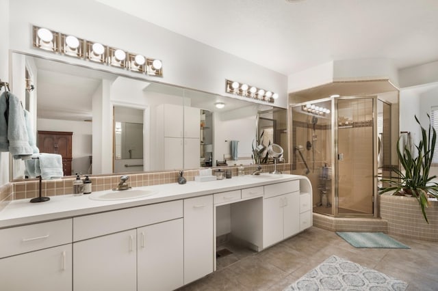 bathroom with vanity, tasteful backsplash, tile patterned floors, and an enclosed shower