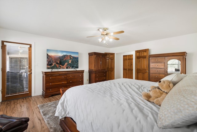 bedroom with multiple windows, light hardwood / wood-style floors, and ceiling fan