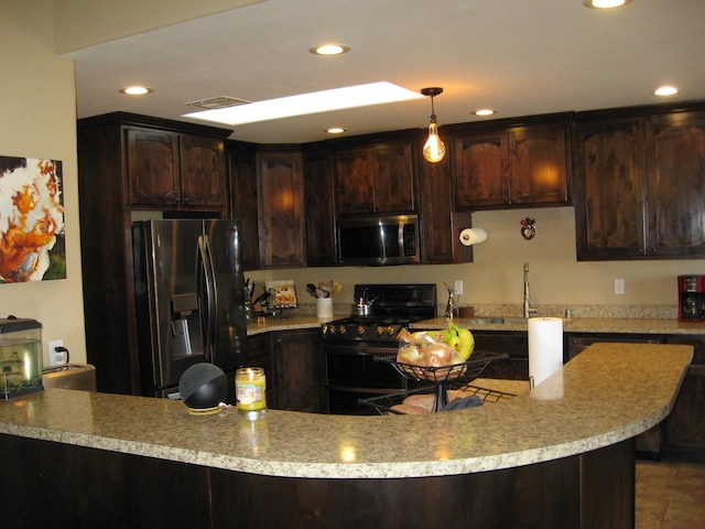 kitchen featuring sink, hanging light fixtures, dark brown cabinets, and appliances with stainless steel finishes