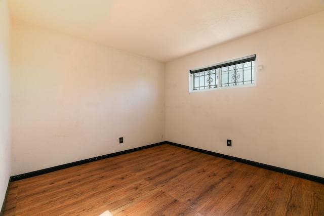 unfurnished room with wood-type flooring