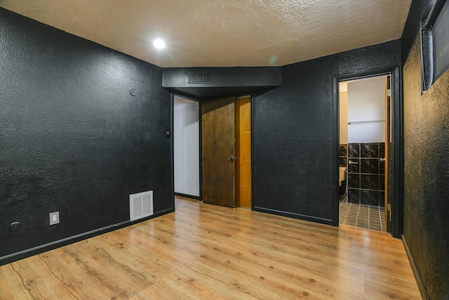 spare room with light wood-type flooring