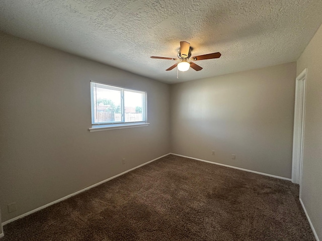 carpeted empty room featuring ceiling fan and a textured ceiling