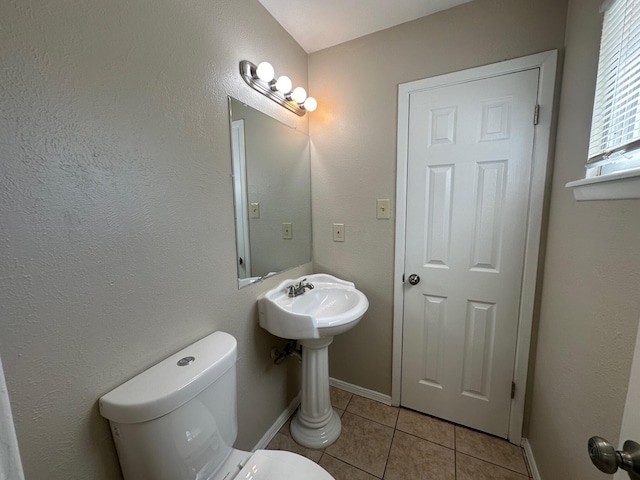 bathroom with tile patterned floors and toilet