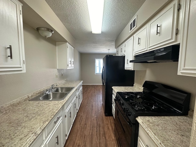 kitchen with white cabinetry, sink, dark wood-type flooring, black gas range oven, and a textured ceiling