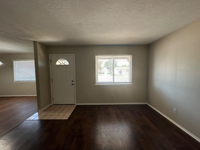 entryway featuring hardwood / wood-style floors and a textured ceiling