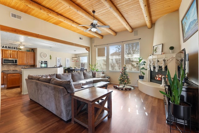 living area featuring wooden ceiling, a fireplace, visible vents, and wood finished floors