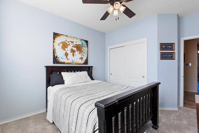 bedroom with a closet, carpet, and baseboards