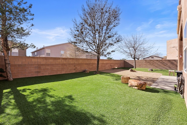 view of yard with a fenced backyard and a patio