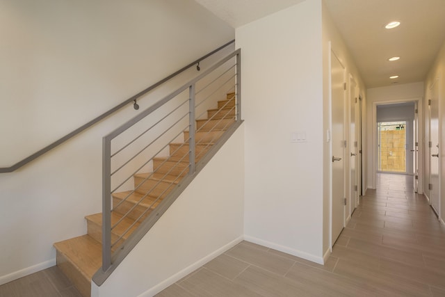 staircase with hardwood / wood-style flooring