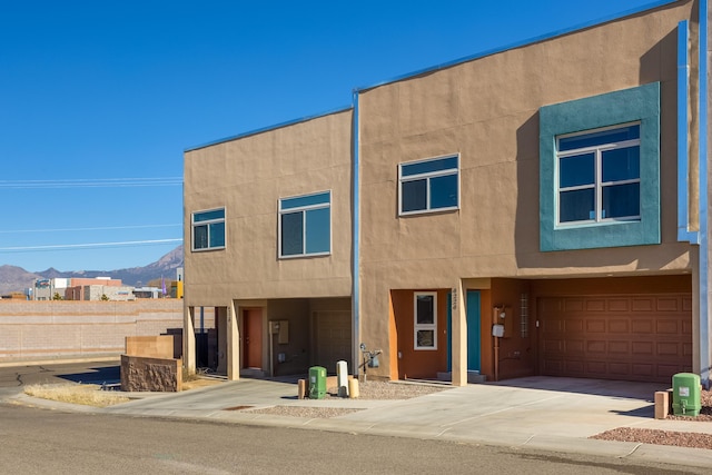 view of front of home with a mountain view and a garage