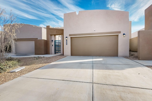 pueblo-style home with a garage