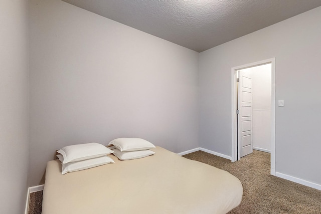 carpeted bedroom featuring a textured ceiling