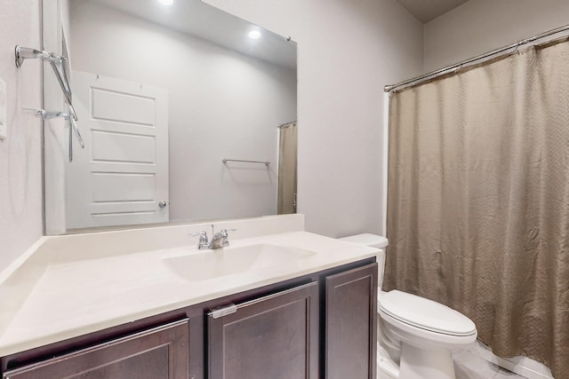 bathroom featuring vanity and toilet