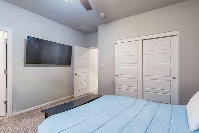 bedroom with ceiling fan, a closet, and carpet floors