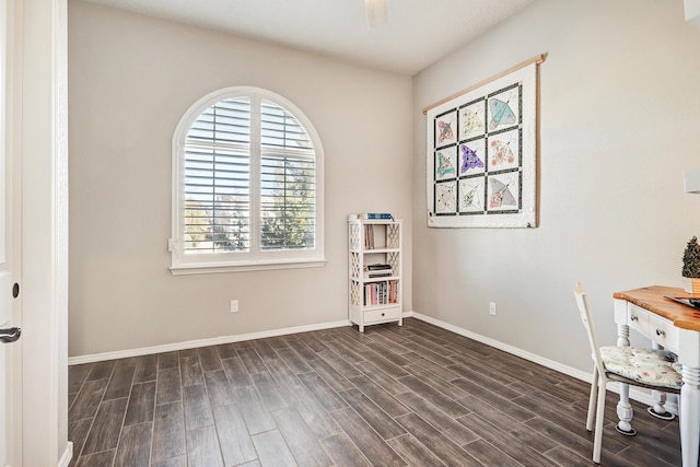 unfurnished office with dark wood-style floors and baseboards