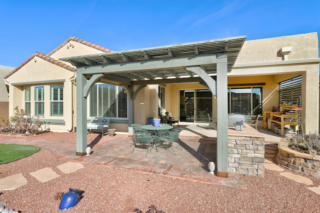 rear view of property with a patio area, outdoor dining area, a pergola, and stucco siding