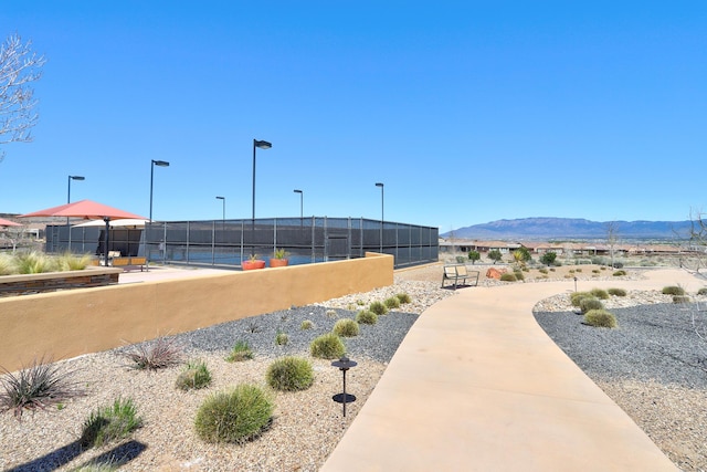 view of home's community featuring a mountain view and fence