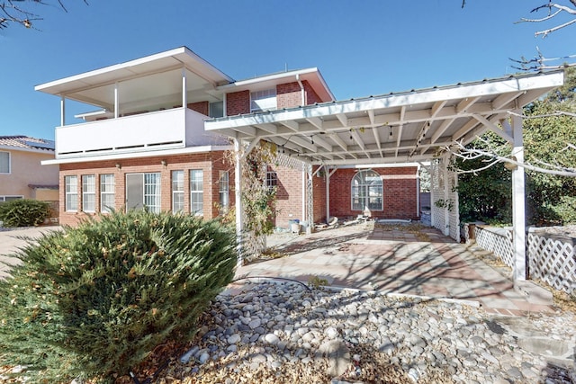 exterior space featuring a carport and a balcony