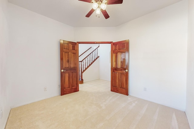 carpeted empty room with ceiling fan