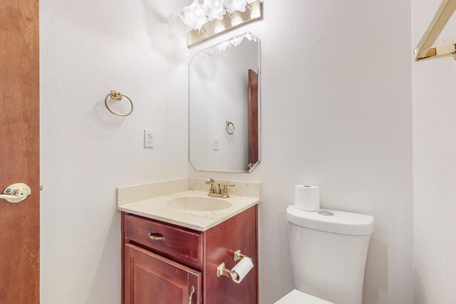 bathroom featuring toilet and vanity