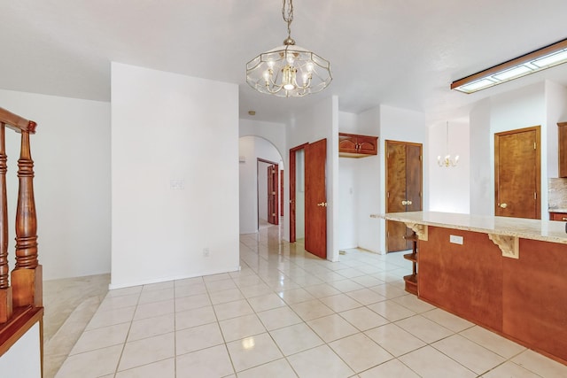 interior space featuring an inviting chandelier and light tile patterned floors