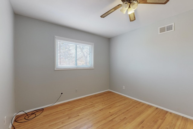 empty room with light wood-type flooring, visible vents, baseboards, and a ceiling fan