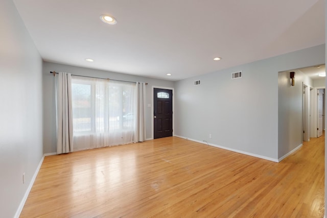 foyer entrance with recessed lighting, light wood-style floors, and baseboards