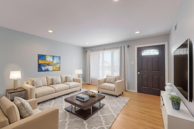 living area with recessed lighting, light wood-style floors, and visible vents