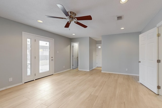 empty room with recessed lighting, visible vents, light wood finished floors, and baseboards