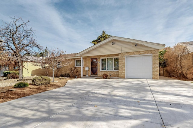 ranch-style house featuring concrete driveway, an attached garage, and brick siding