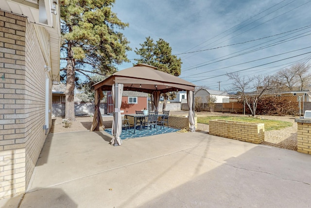 view of patio featuring outdoor dining space, a gazebo, and a fenced backyard