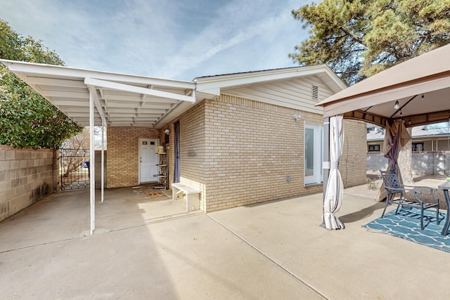 view of patio featuring a gazebo and a carport