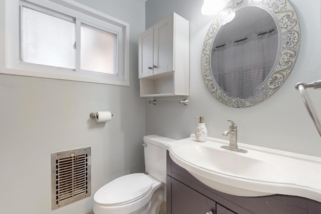 full bathroom featuring visible vents, toilet, and vanity