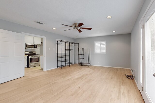 empty room with recessed lighting, visible vents, light wood-style flooring, and baseboards