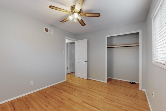 unfurnished bedroom with light wood-style flooring, baseboards, visible vents, and a closet