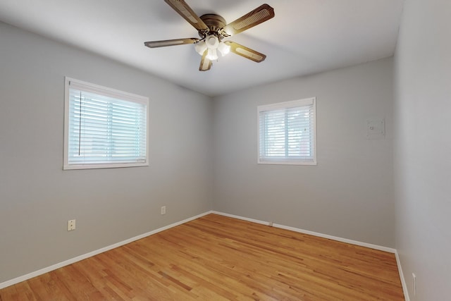 empty room with ceiling fan, baseboards, and light wood-style flooring