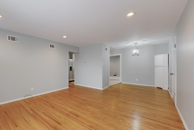 unfurnished room featuring recessed lighting, visible vents, and light wood-style floors