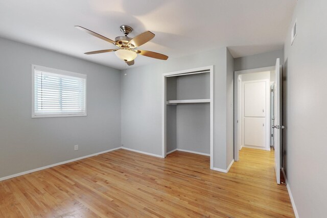 unfurnished bedroom featuring a closet, baseboards, light wood-style floors, and visible vents