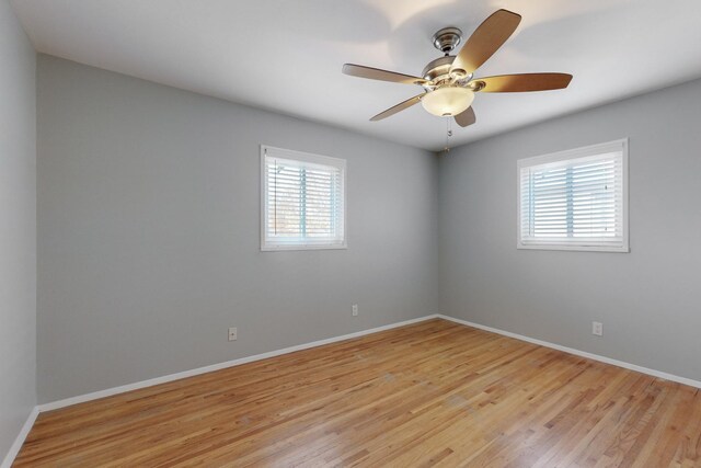 spare room with light wood-type flooring and a healthy amount of sunlight