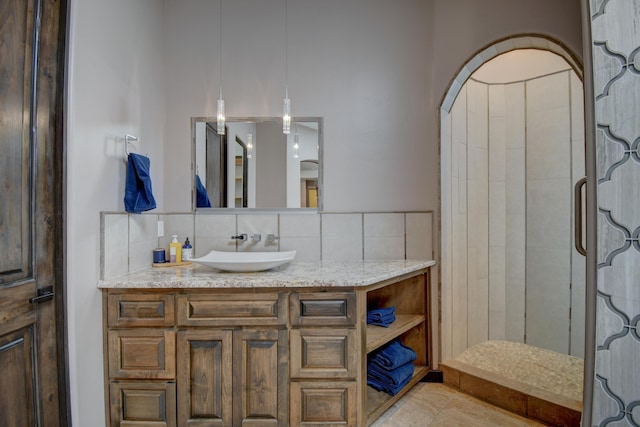 bathroom featuring a shower stall, vanity, and decorative backsplash